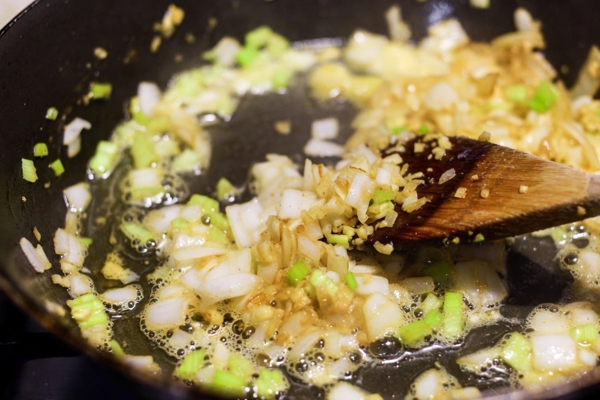garlic onion and celery cooking in melted butter in a skillet