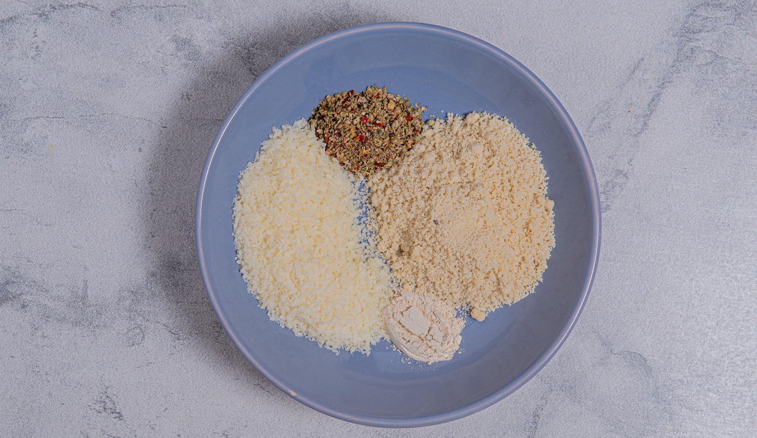 Almond flour and parmesan mixture to be stirred together to create coating for baked avocado fries