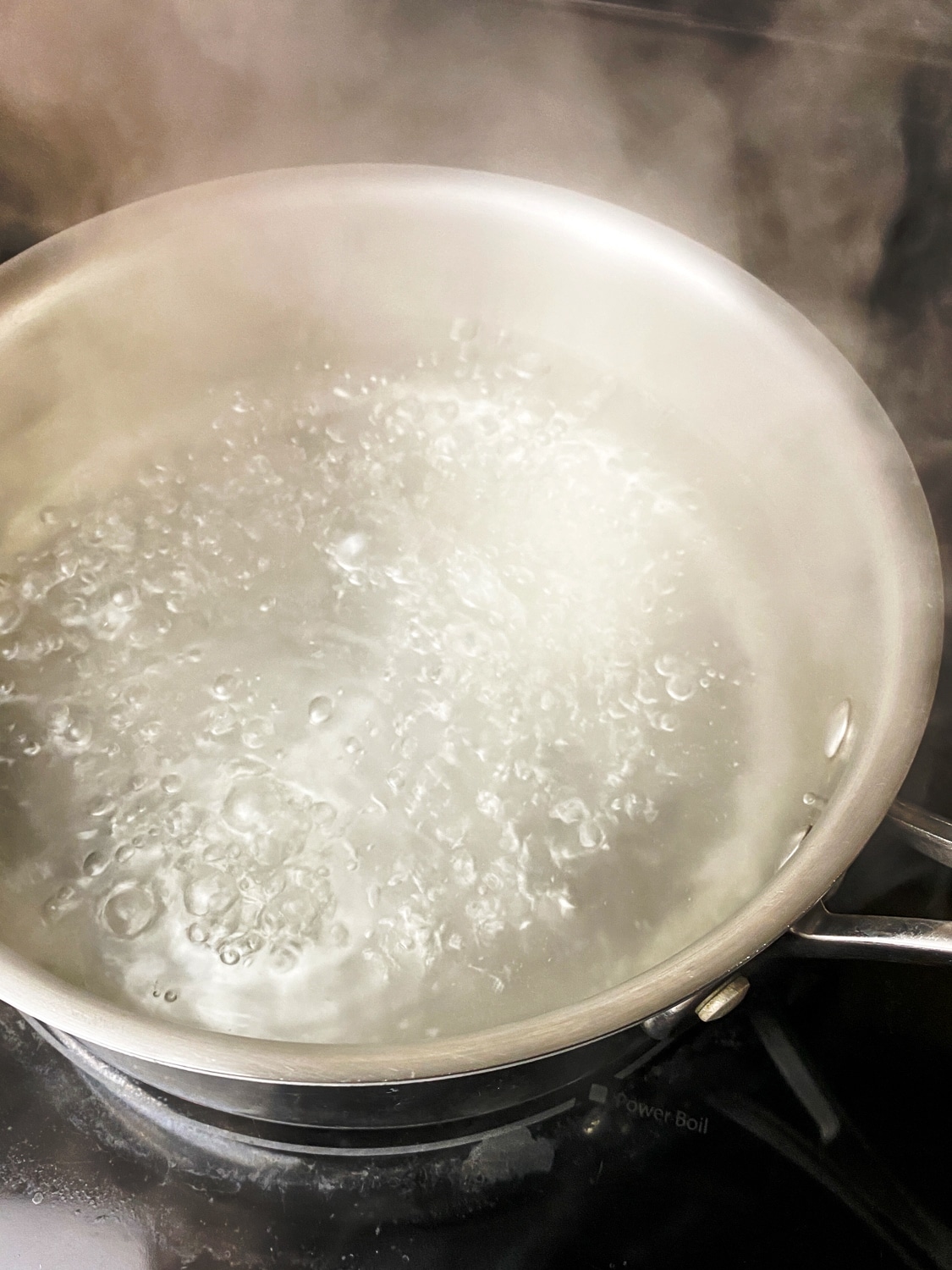 medium saucepan with water and white vinegar at a gentle simmer for poaching eggs