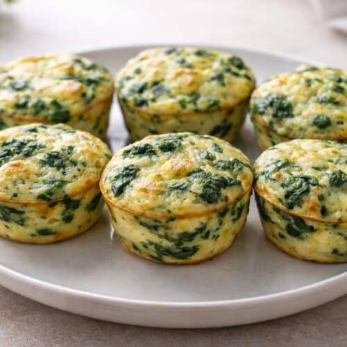 low-carb spinach and cheese egg muffins on plate freshly baked golden tops